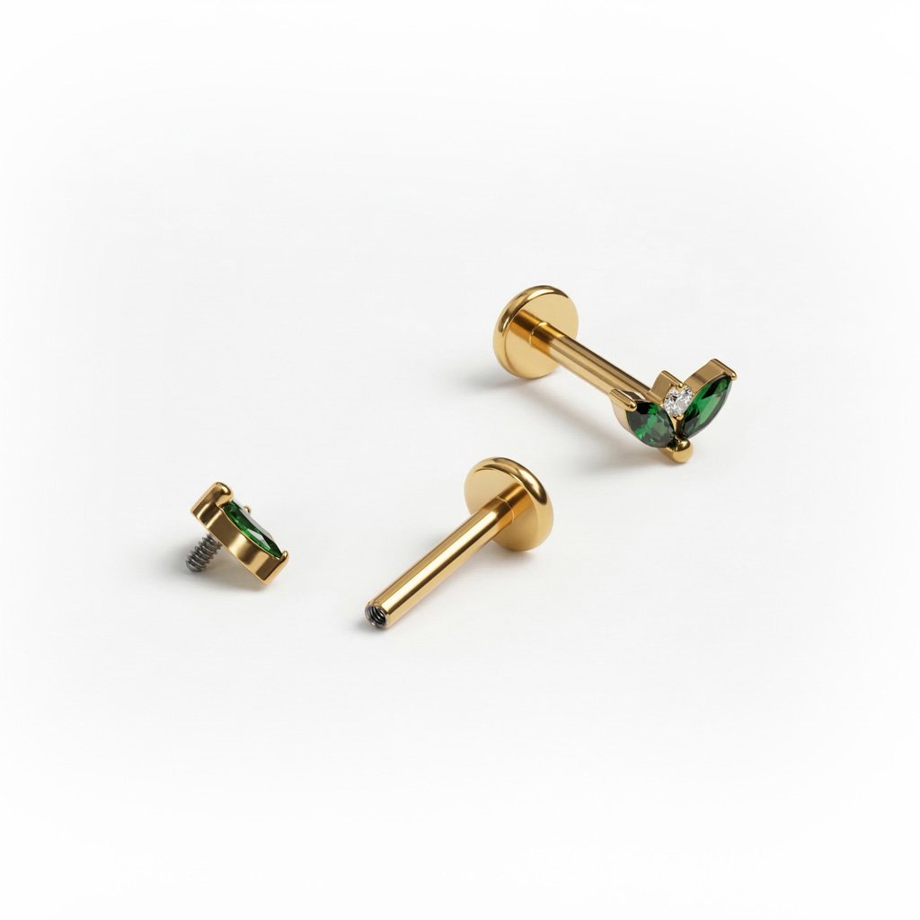 Titāna labrete ar smaragda krāsas akmentiņu pāri